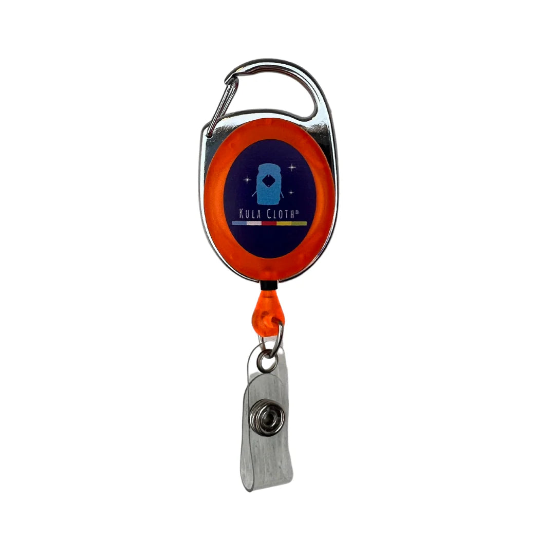 Retractable badge holder with orange clip and blue label on a white background