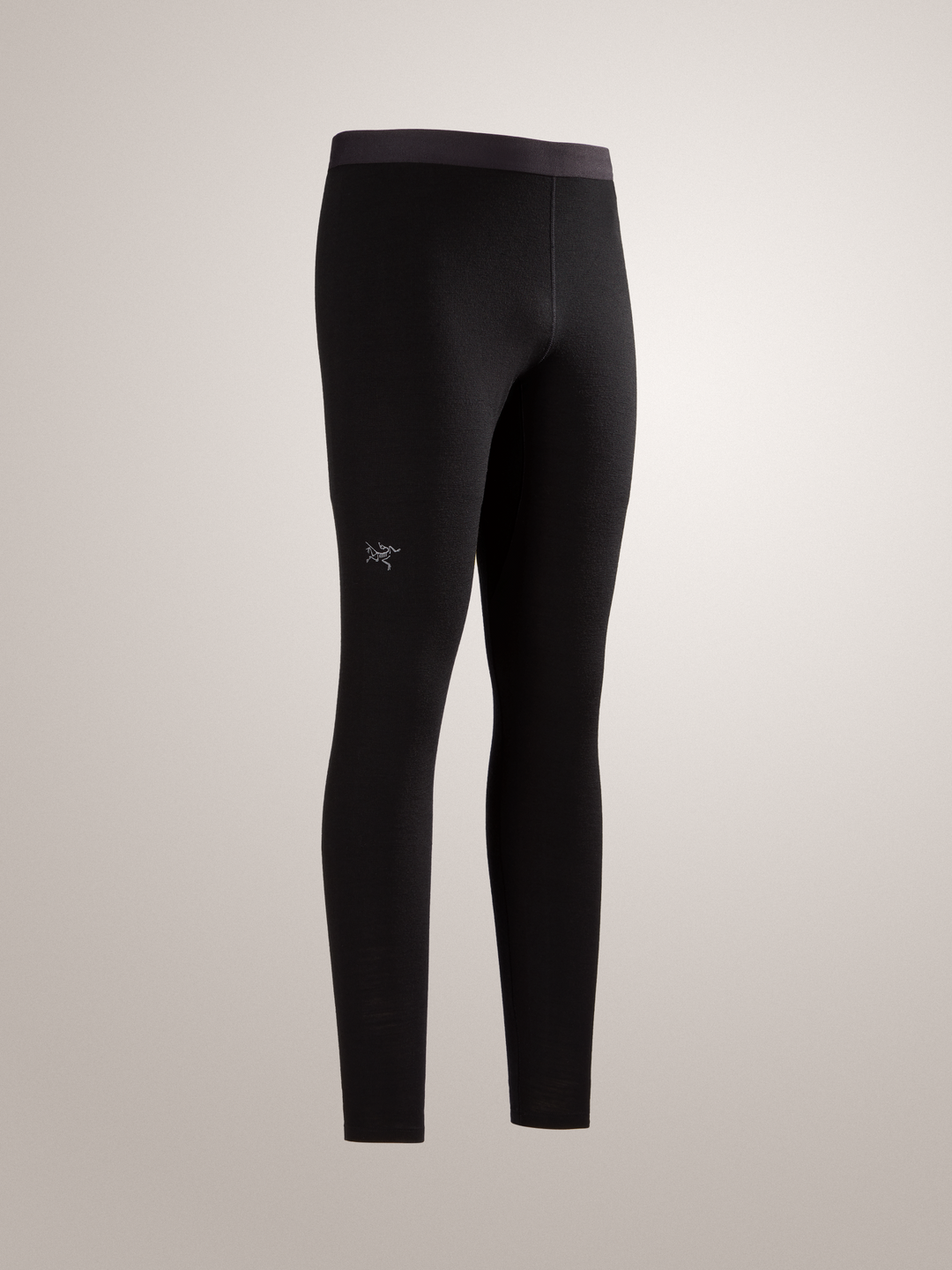 Black Arc'teryx Rho merino wool leggings with a brand logo on a light gray background