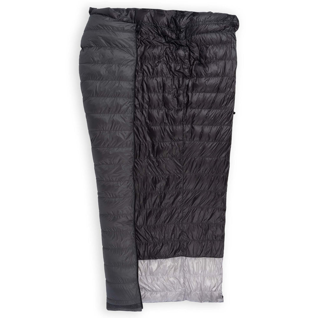 Half unzipped Feathered Friends Flicker UL Ultralight Down Quilt Sleeping Bag in dark Graphite gray showing the interior on a white background