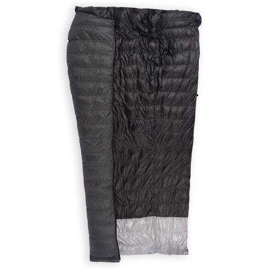 Half unzipped Feathered Friends Flicker UL Ultralight Down Quilt Sleeping Bag in dark Graphite gray showing the interior on a white background
