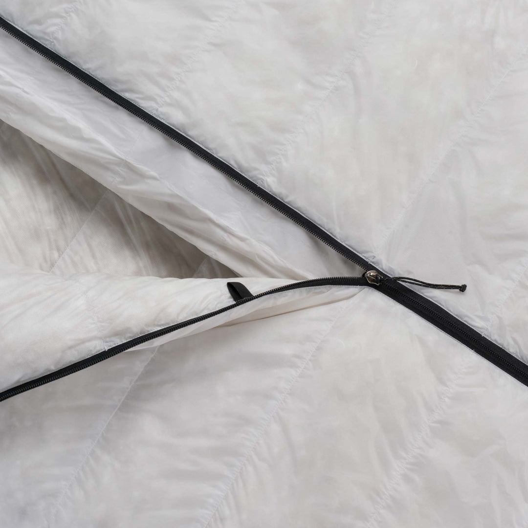 Close up detail of the zipper of Feathered Friends Flicker UL ultralight quilt sleeping bag
