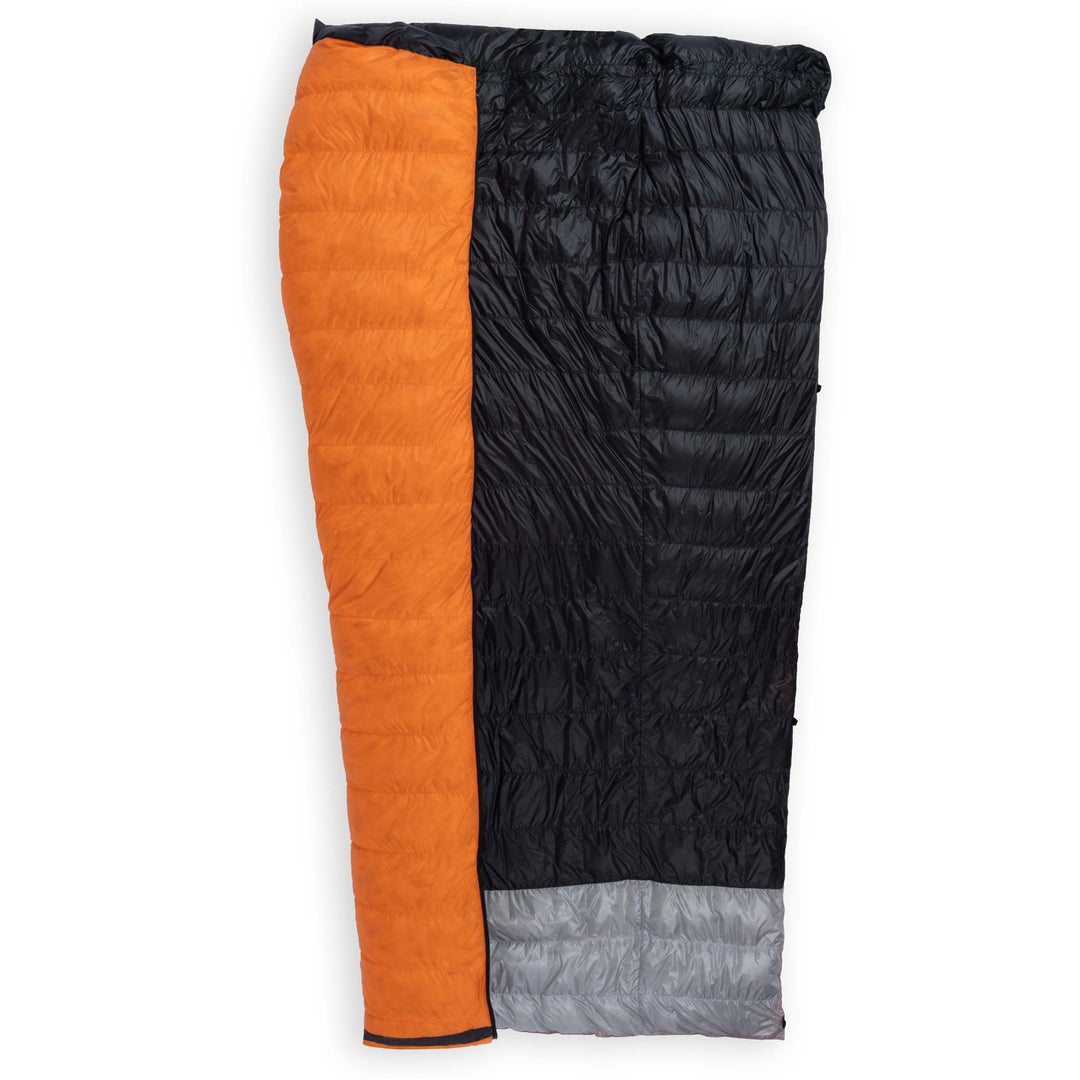 Feathered Friends Flicker UL Wide Ultralight Down Quilt Sleeping Bag in Flame Orange half unzipped to display the interior