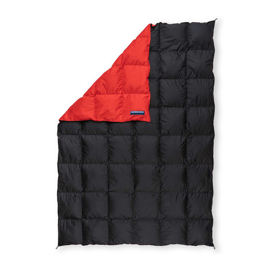 Back view of a Red and Black Feathered Friends water-resistant down blanket on white background