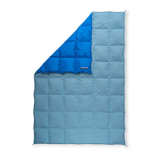 Light blue and dark blue Feathered Friends water-resistant down blanket on a white background