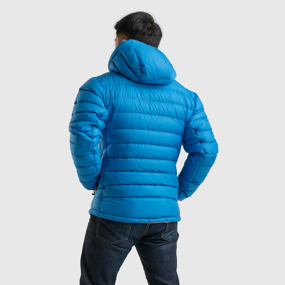 Back view studio photo of a man wearing blue sky color Feathered Friends Eos Jacket