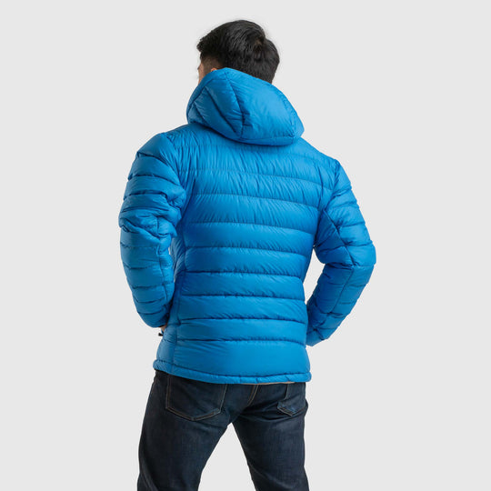 Back view studio photo of a man wearing blue sky color Feathered Friends Eos Jacket