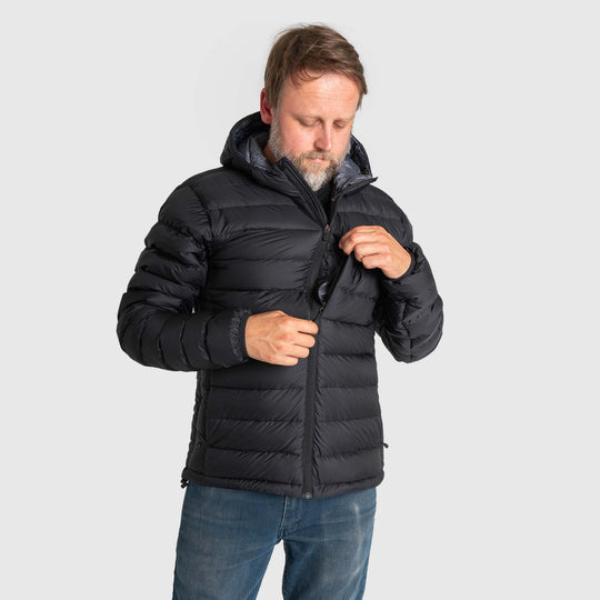 Studio front pocket detail view of man wearing a black Men's Feathered Friends Eos Down Jacket