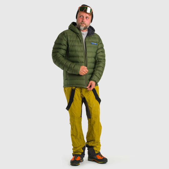 Studio front view of man zipping up a chive green Men's Feathered Friends Eos Down Jacket