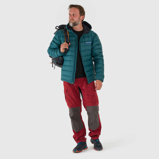 Studio front view of man wearing a deep teal Men's Feathered Friends Eos Down Jacket