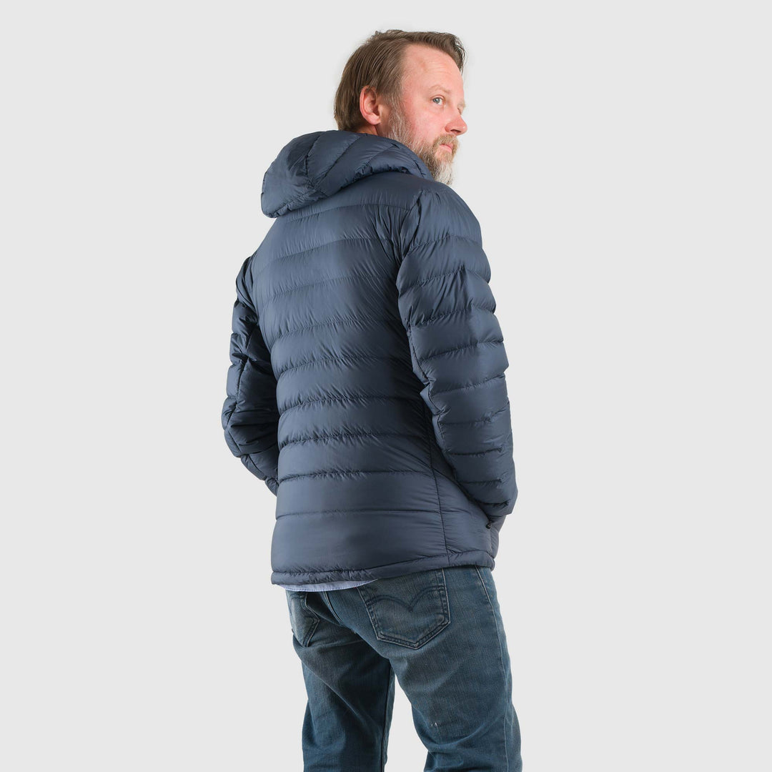 Studio back view of man wearing a midnight blue Men's Feathered Friends Eos Down Jacket