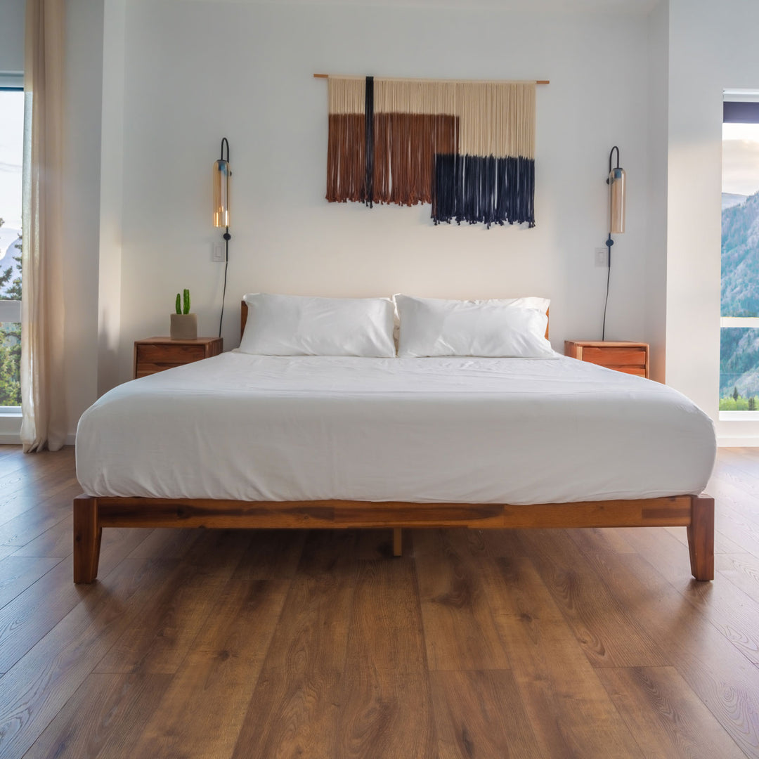 White Feathered Friends Organic Cotton Fitted sheet and Two Pillowcases on a wood bed