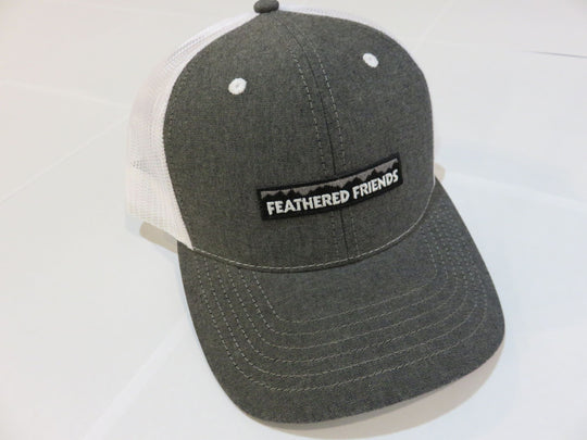 Studio image Feathered Friends Pro Style Mountain Logo Trucker Hat white and chambray black colors