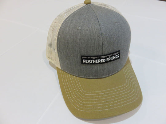Studio image Feathered Friends Pro Style Mountain Logo Trucker Hat heather grey and amber stone colors