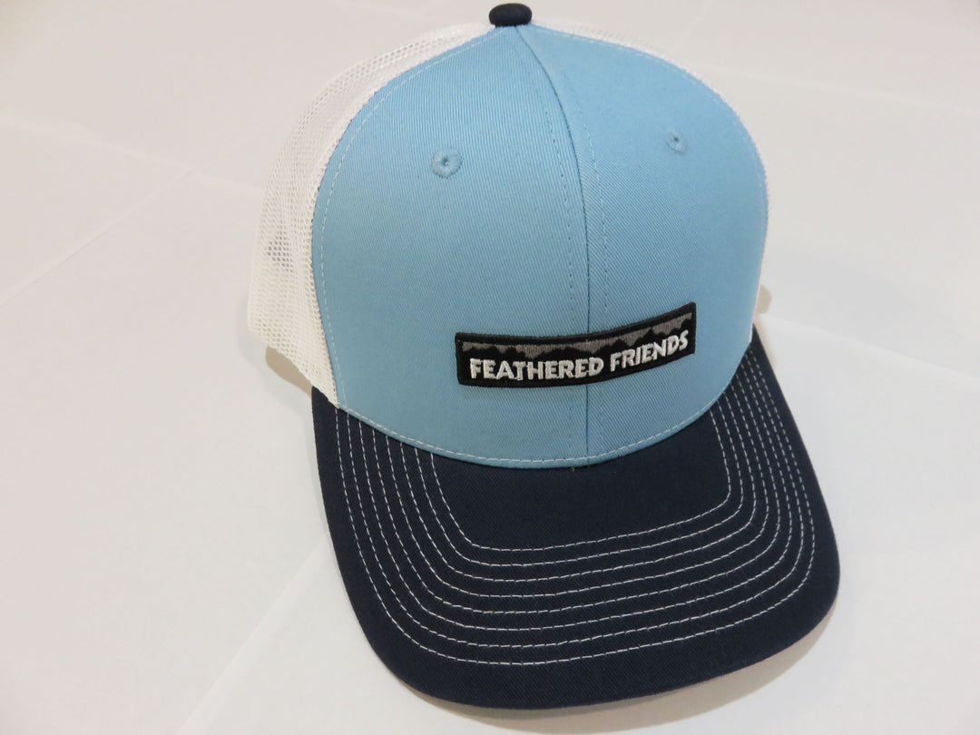 Studio image Feathered Friends Pro Style Mountain Logo Trucker Hat light blue, navy and white colors