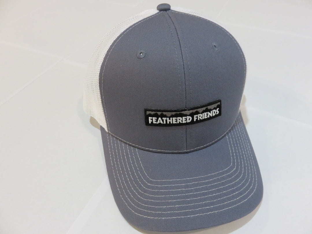 Studio image Feathered Friends Pro Style Mountain Logo Trucker Hat steel blue and white colors