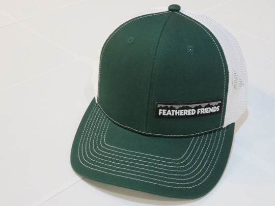 Studio image Feathered Friends Pro Style Offset Logo Trucker Hat green and white colors
