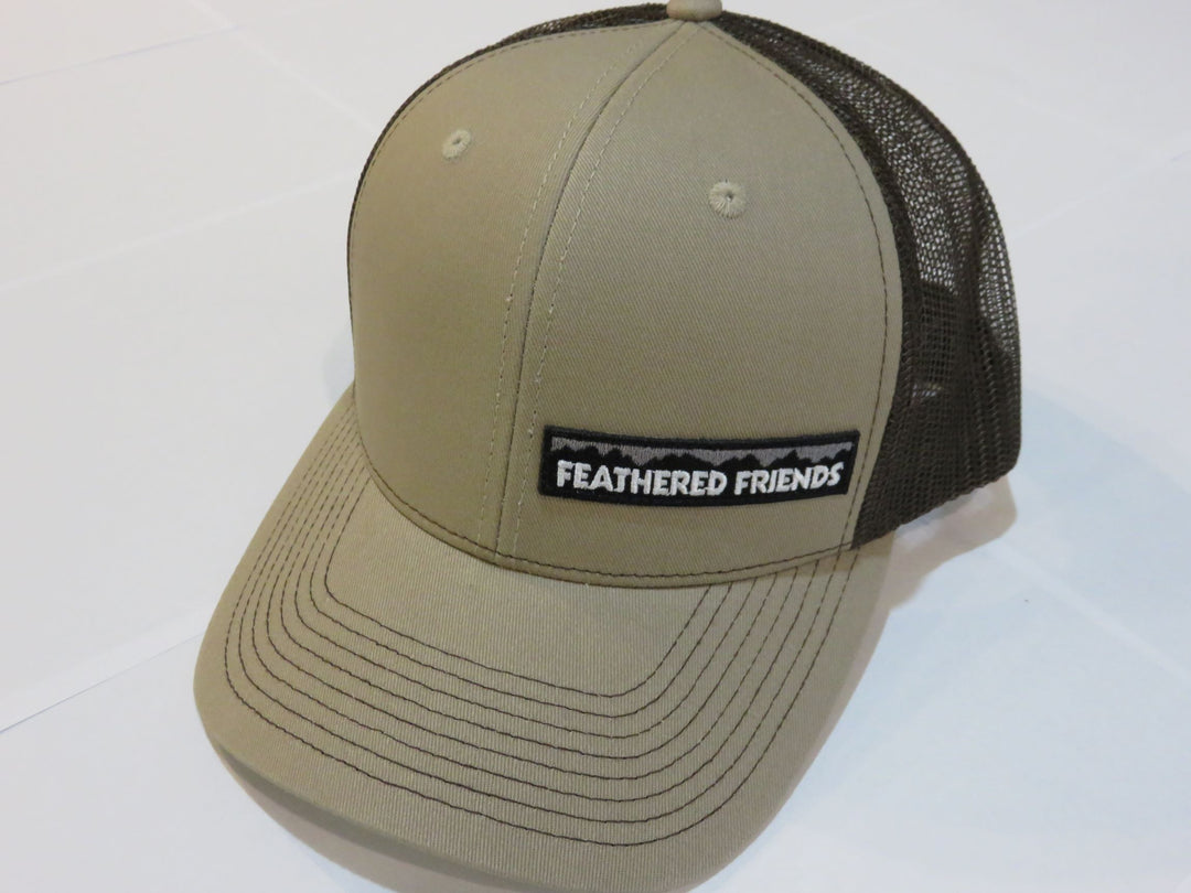 Studio image Feathered Friends Pro Style Offset Logo Trucker Hat khaki and brown colors