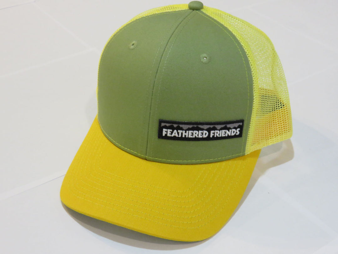 Studio image Feathered Friends Pro Style Offset Logo Trucker Hat light green and yellow colors