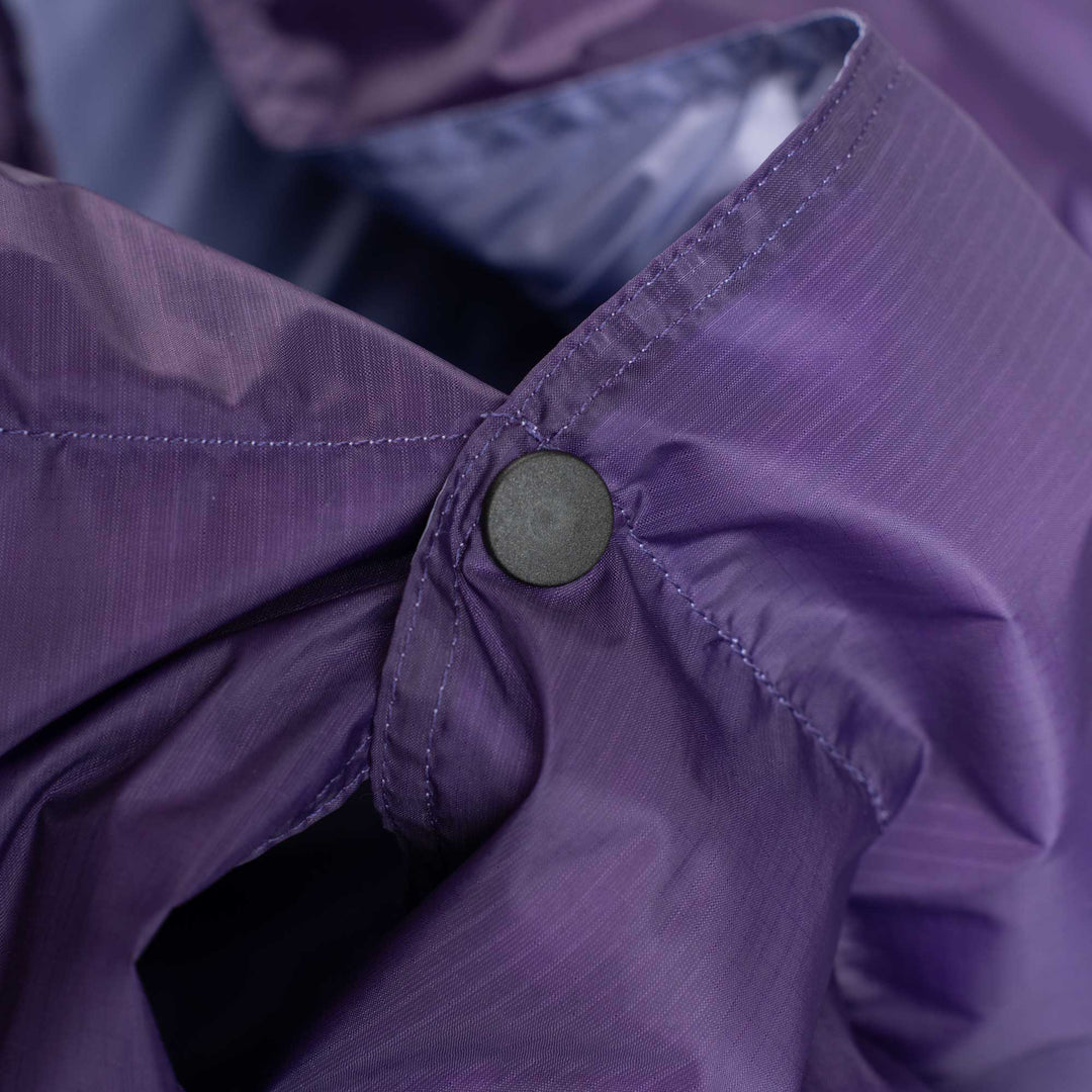 Close up snap button detail on purple Feathered Friends down blanket