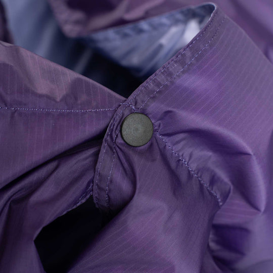 Close up snap button detail on purple Feathered Friends down blanket