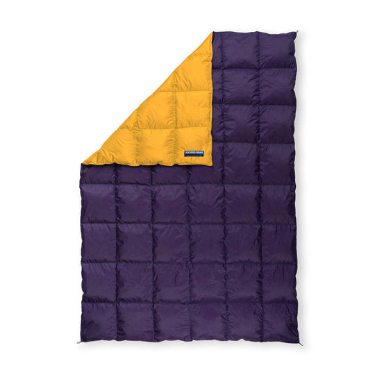 Feathered Friends purple and yellow ultralight down blanket on a white background