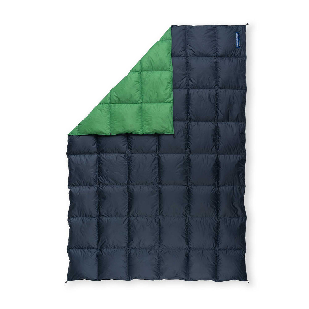 Feathered Friends navy blue and clover green ultralight down blanket on white background
