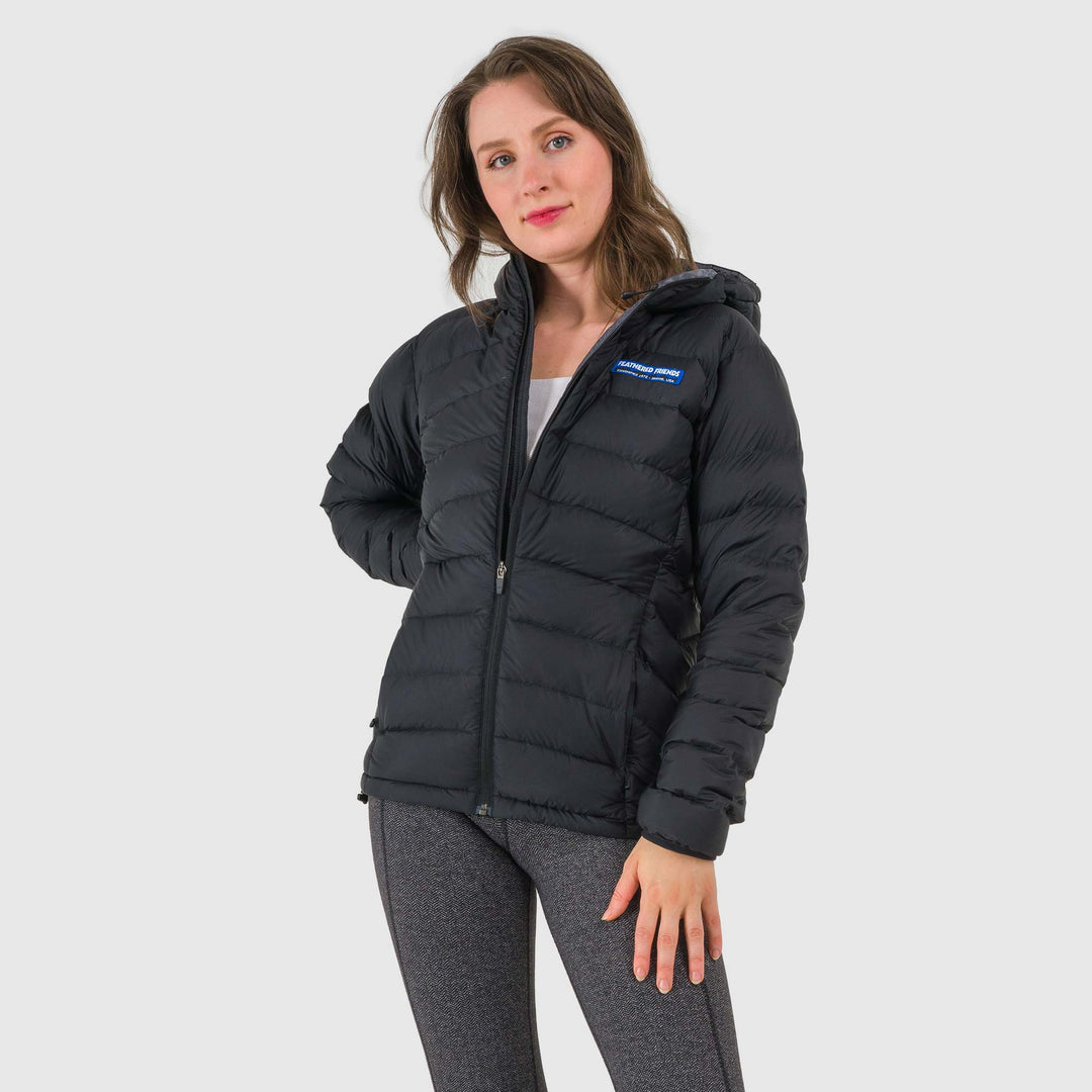 Studio front view of woman wearing a black Women's Feathered Friends Eos Down Jacket