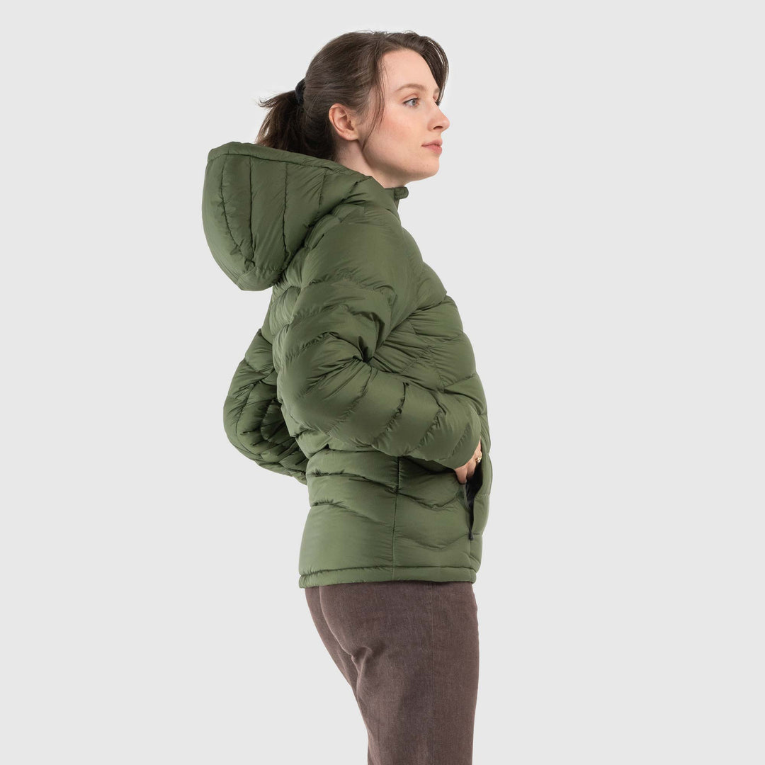 Studio side view of woman wearing a chive green Women's Feathered Friends Eos Down Jacket