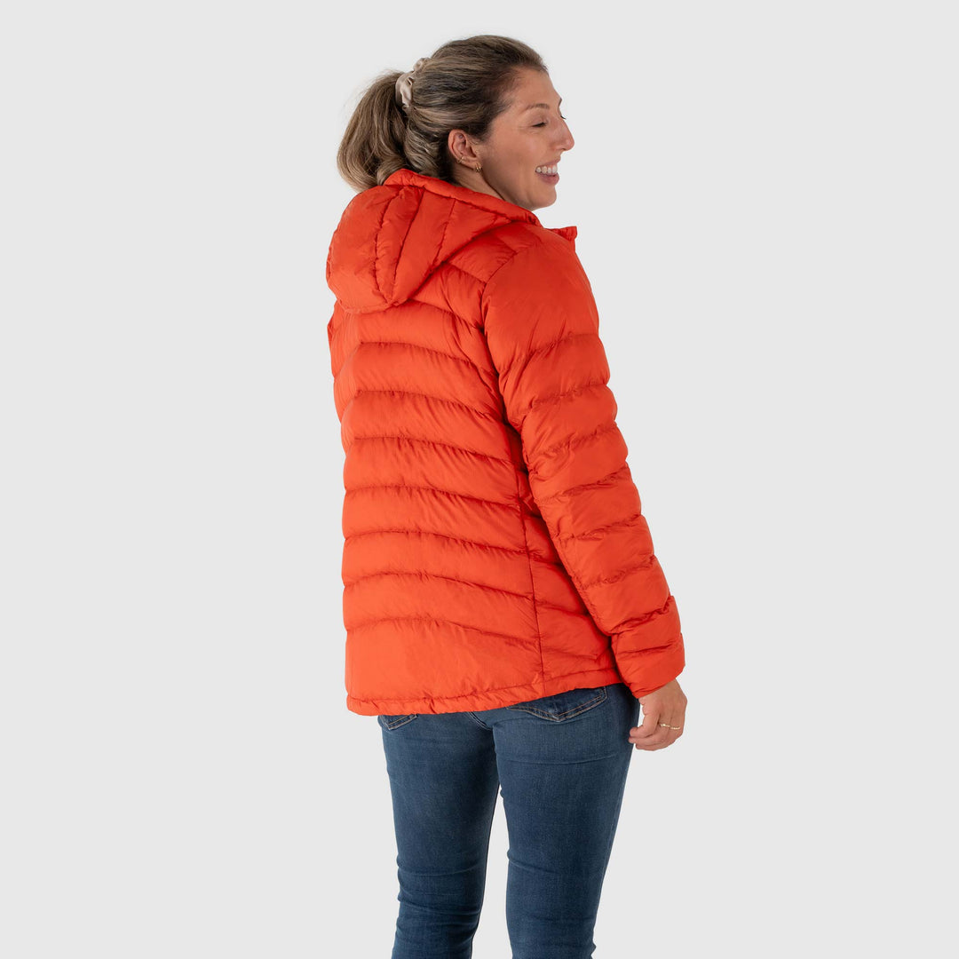 Studio back view of woman wearing a rorange Women's Feathered Friends Eos Down Jacket