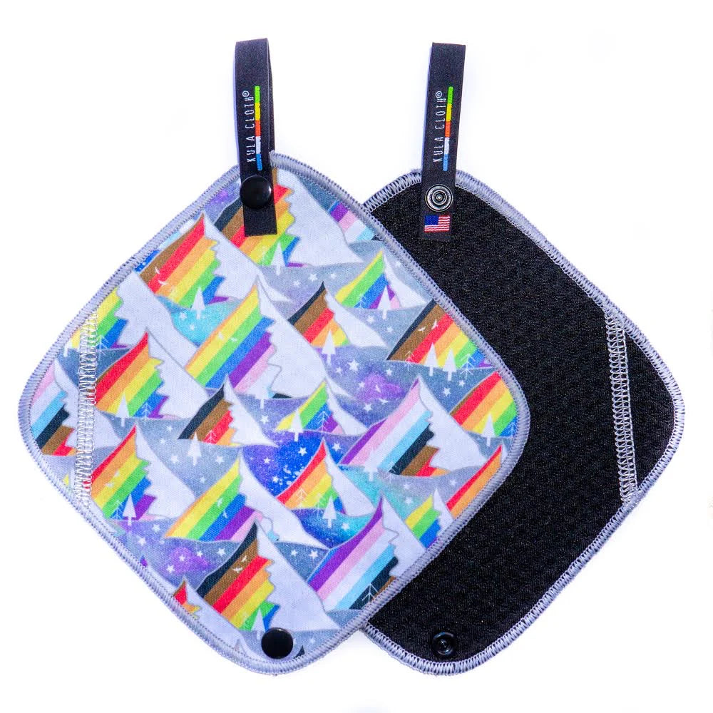 Two pot holders with pride mountain designs on a white background