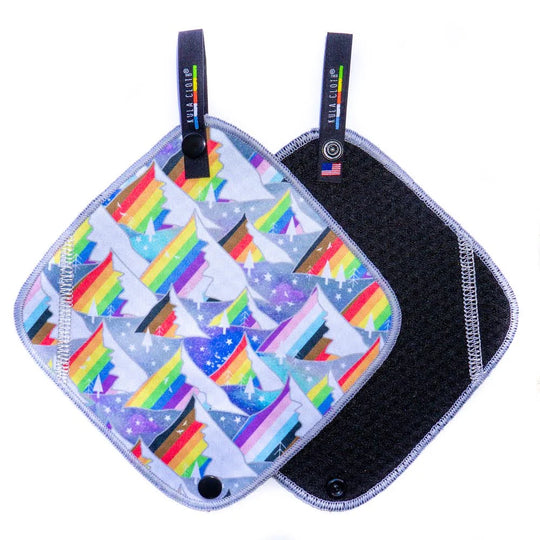 Two pot holders with pride mountain designs on a white background