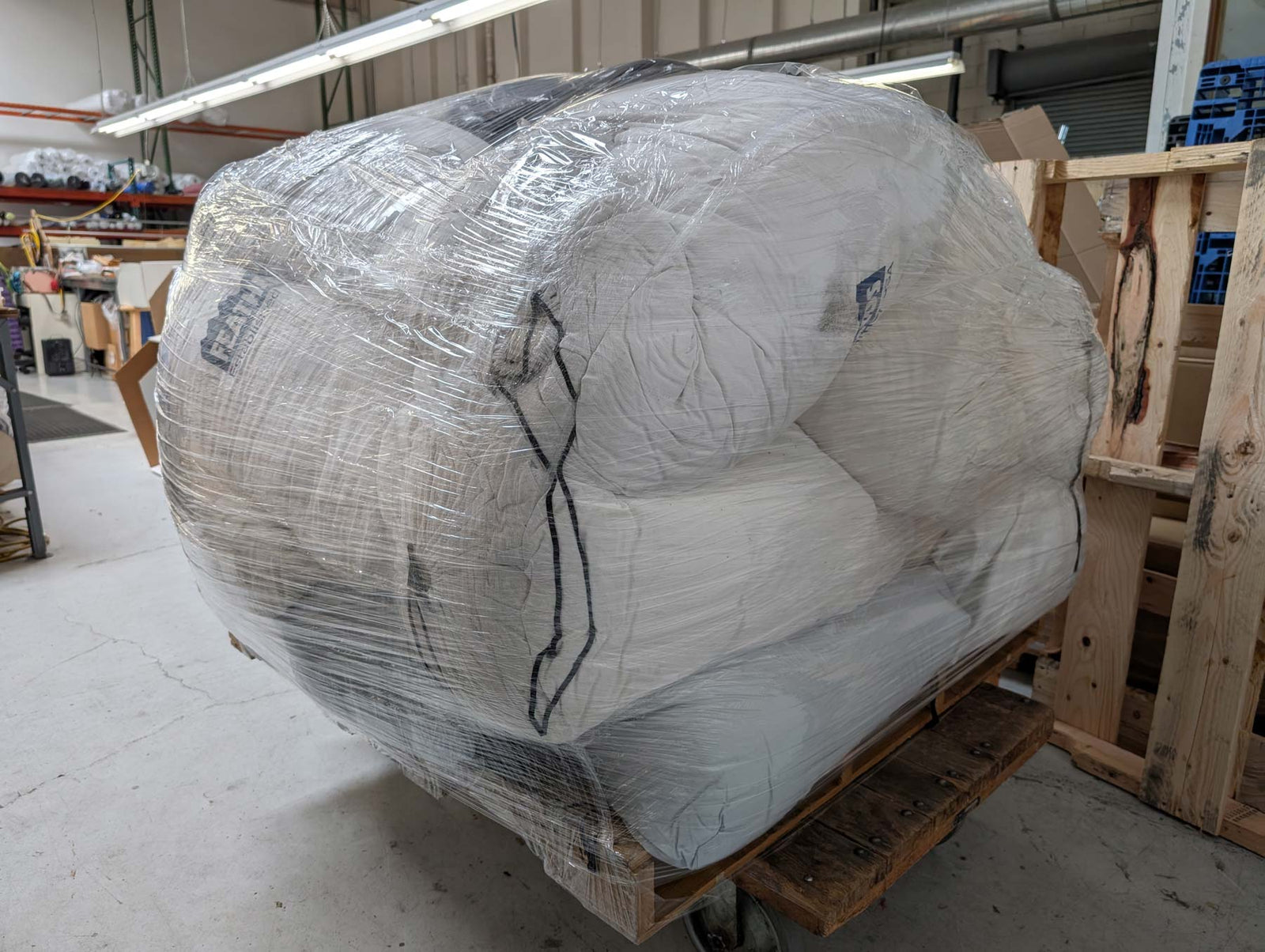 A pallet of old Feathered Friends down products being prepared to be sent to Tersus for down recycling