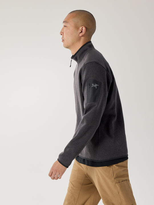 Man wearing Black Heather Arc'teryx Covert jacket with a brand logo on a white background