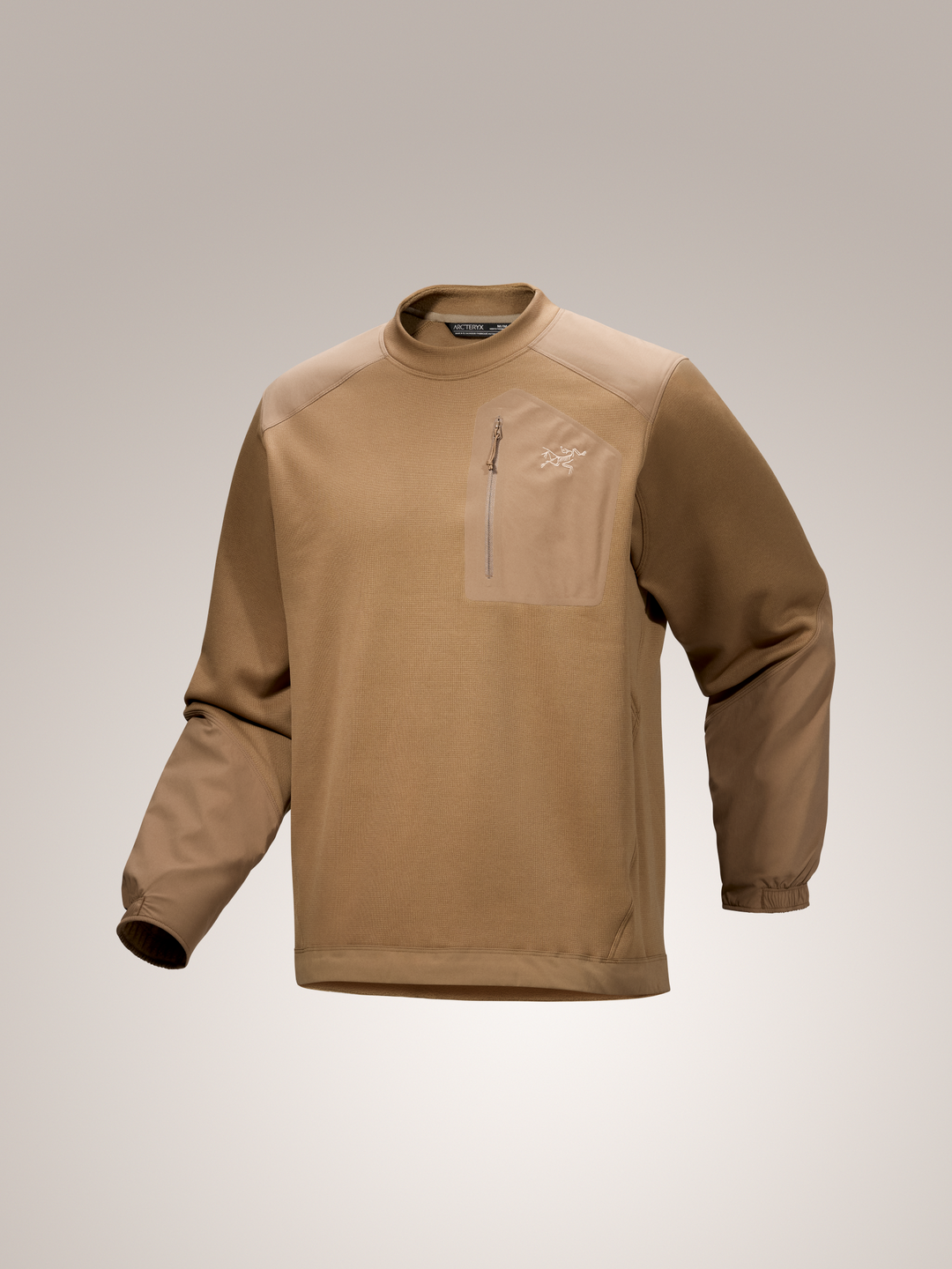 Canvas tan Arc'teryx Konseal crew neck long-sleeve shirt with a zipper on a light gray background