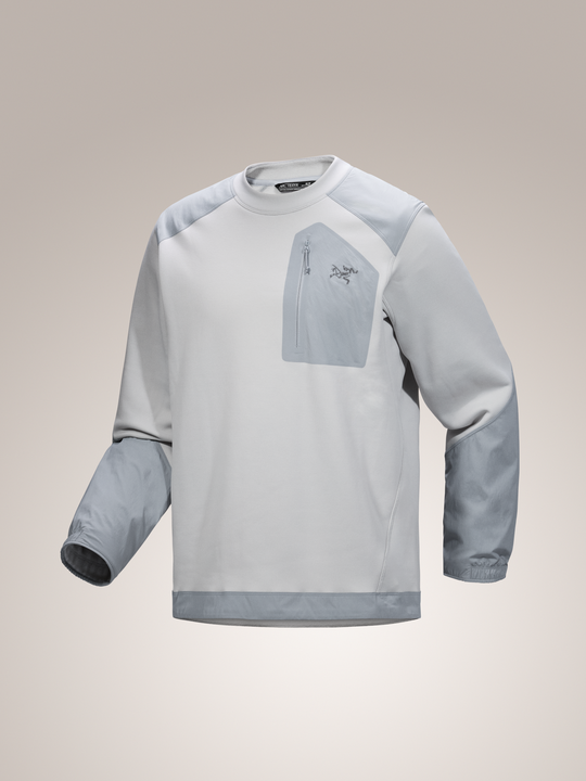 Solitude light gray Arc'teryx Konseal crew neck fleece pullover with blue accents on a beige background