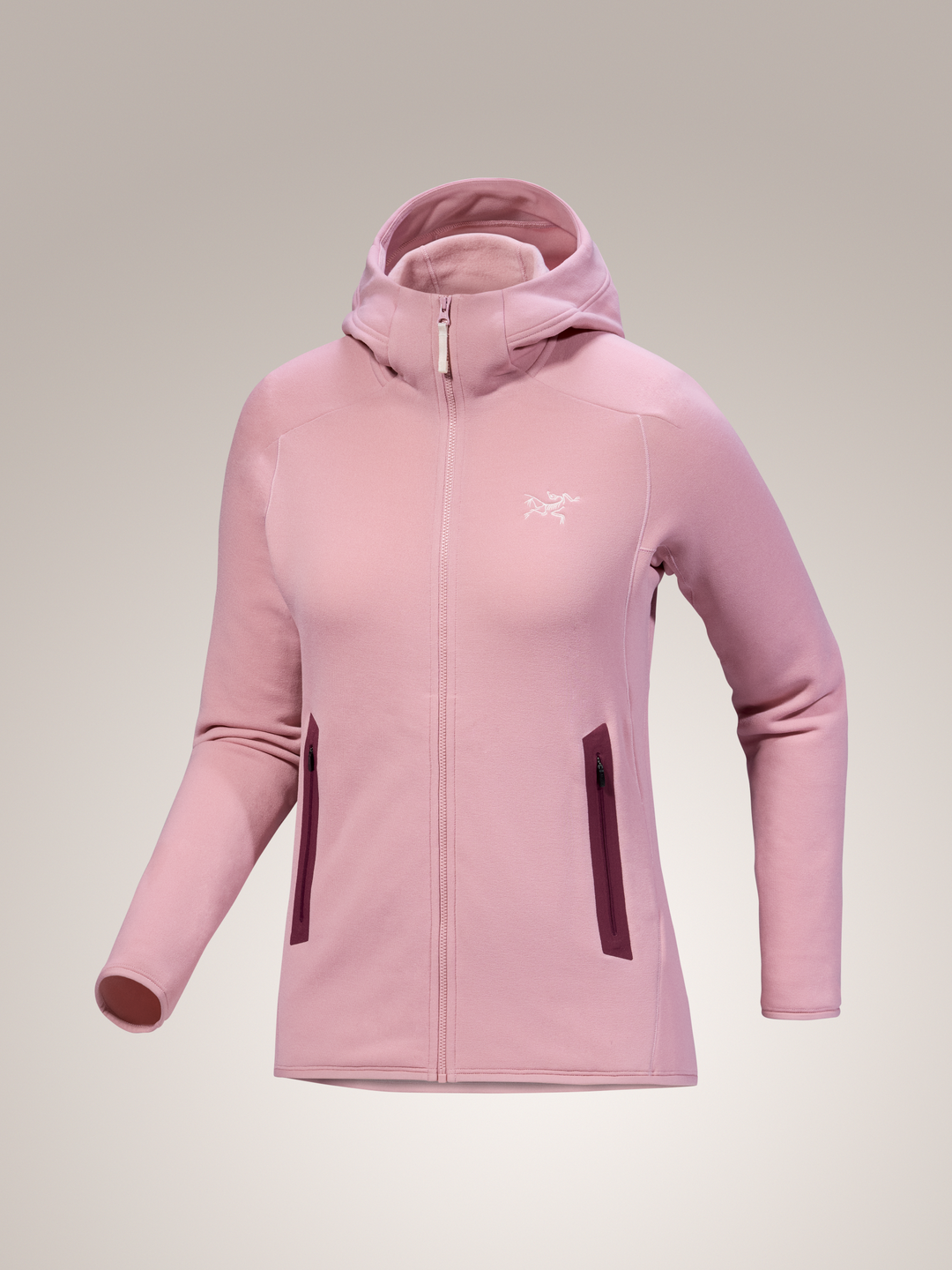 Bliss pink Arc'teryx Kyanite hoodie with a brand logo on a light gray background