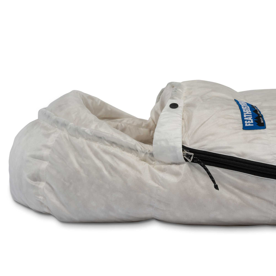 Side view of the hood and side zipper of Feathered Friends Egret UL women's ultralight down sleeping bag in Undyed Pertex Quantum Pro on white background