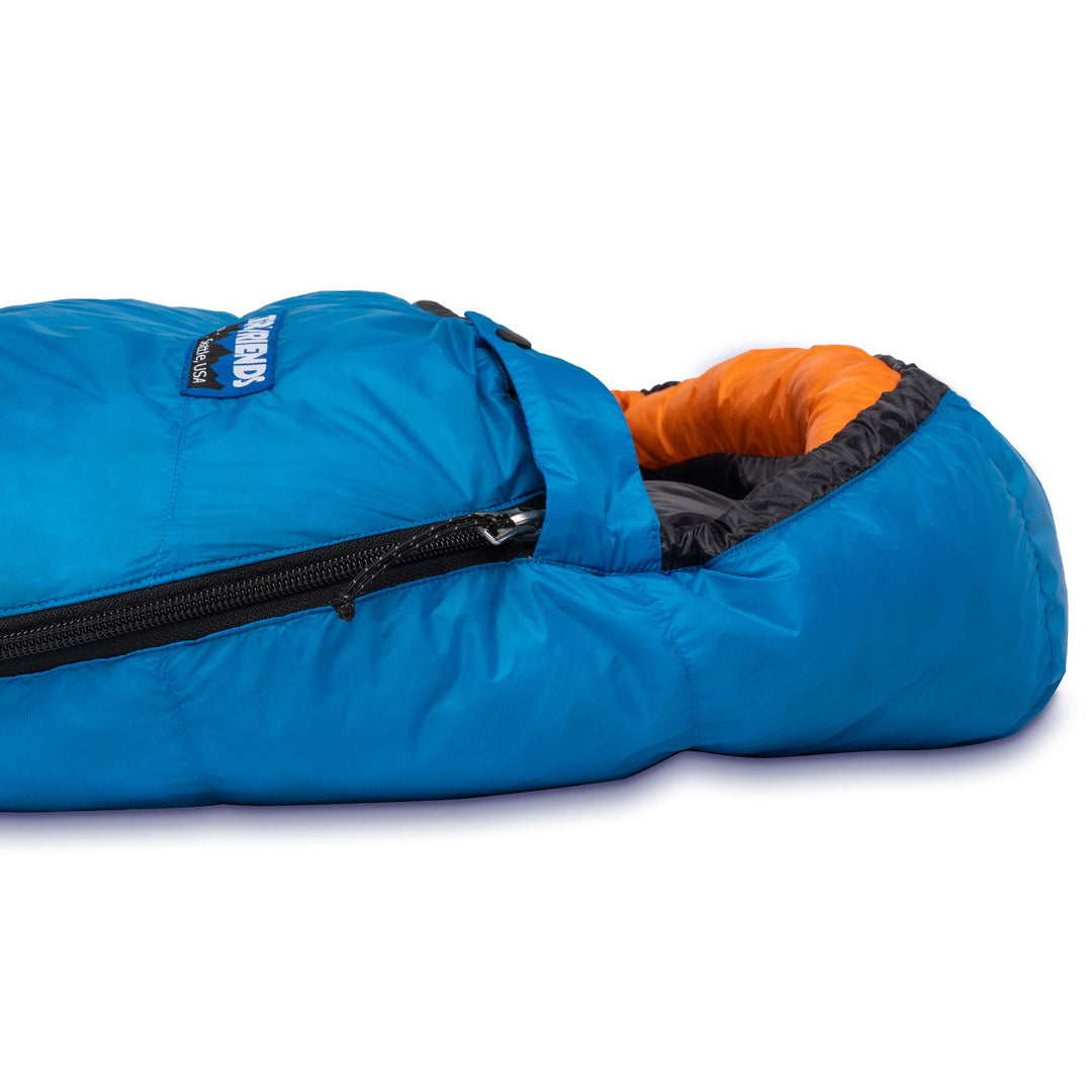 Side view of the hood and side zipper of Feathered Friends Hummingbird UL ultralight down sleeping bag in Cerulean blue with Flame orange hood trim on a white background