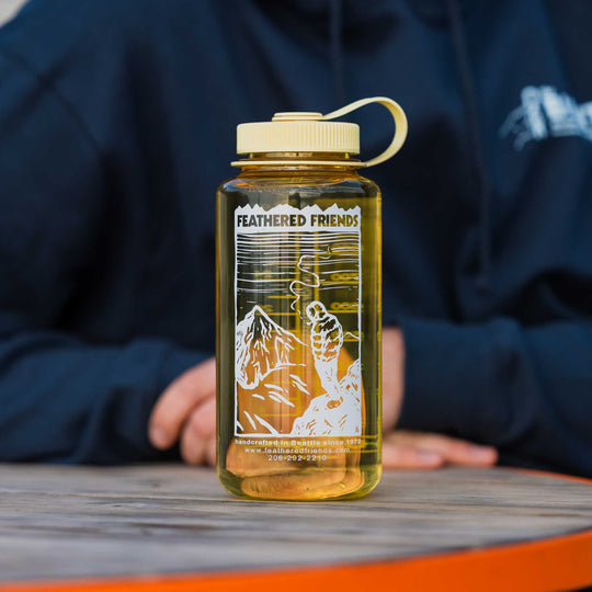 Yellow Feathered Friends Nalgene water bottle with mountain drawing design
