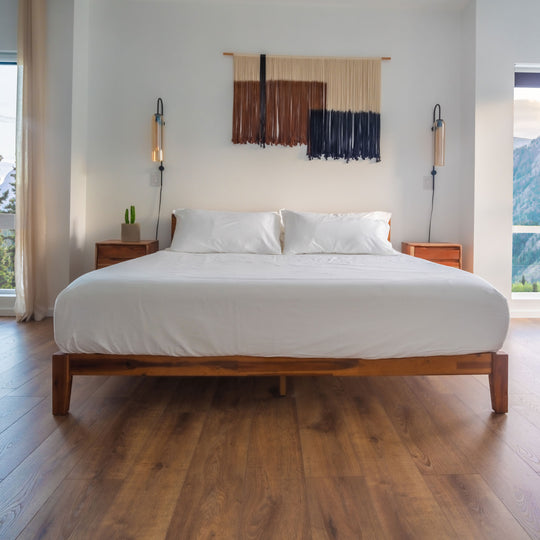 White Feathered Friends Organic Cotton Fitted sheet and Two Pillowcases on a wood bed