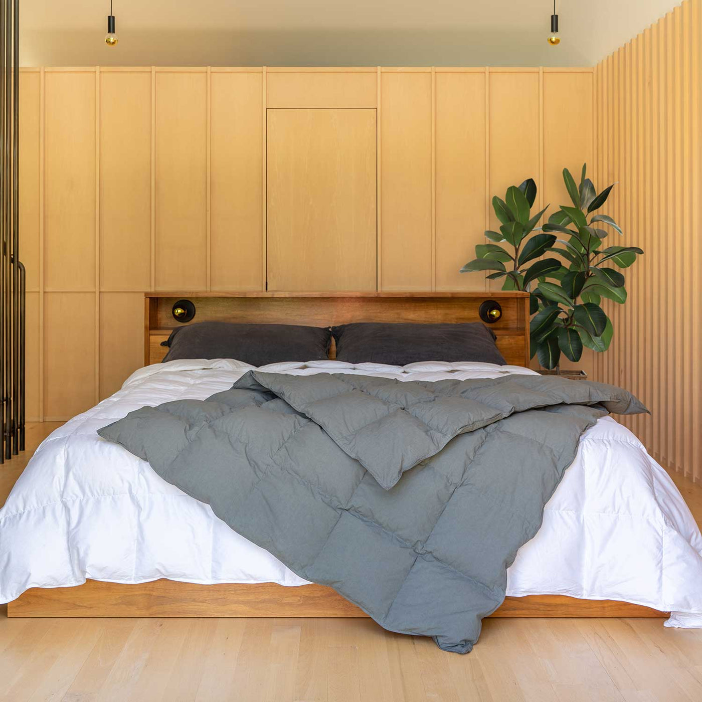 Bedroom with wooden headboard and Cascade gray Down Throw