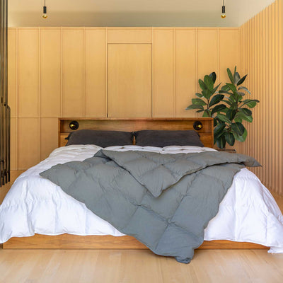 Bedroom with wooden headboard and Cascade gray Down Throw