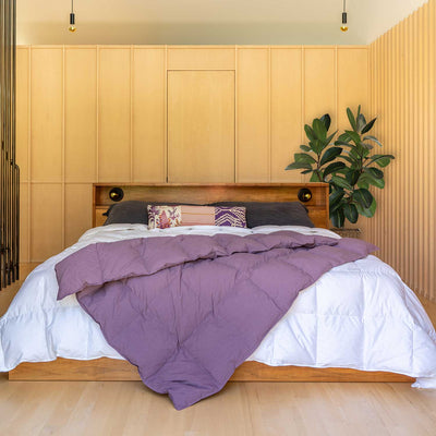 Bedroom with wooden headboard and Dusky Purple Down Throw