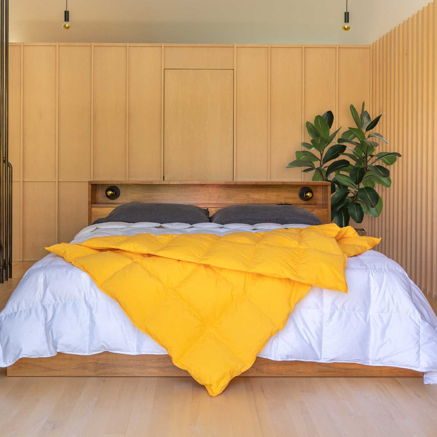 Bedroom with wooden headboard and Marigold yellow Down Throw