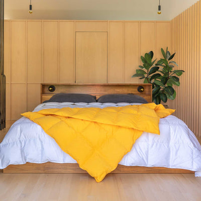 Bedroom with wooden headboard and Marigold yellow Down Throw