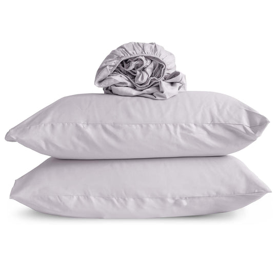 Studio photo of Thistle-color Feathered Friends Organic Cotton Fitted Sheet rolled up on two pillow cases