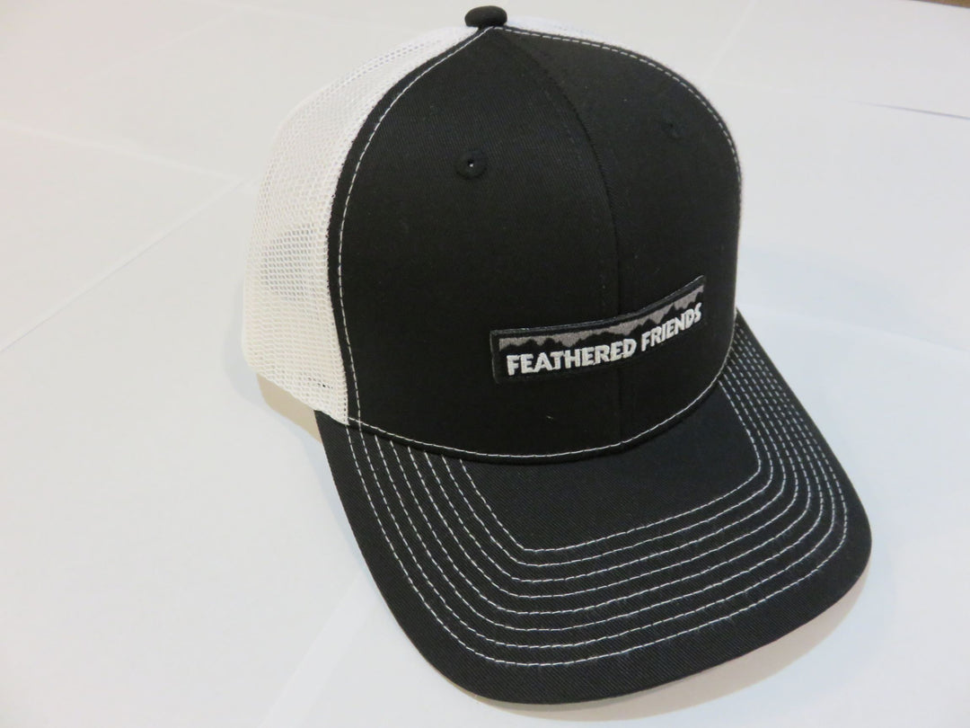 Studio image Feathered Friends Pro Style Mountain Logo Trucker Hat black and white colors