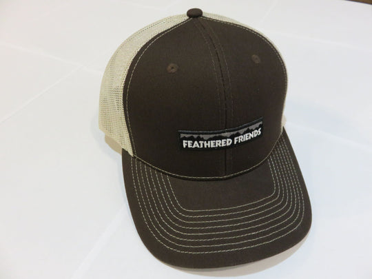 Studio image Feathered Friends Pro Style Mountain Logo Trucker Hat charcoal brown and tan colors