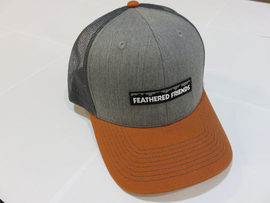 Studio image Feathered Friends Pro Style Mountain Logo Trucker Hat heather grey and burnt orange colors
