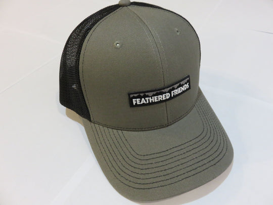 Studio image Feathered Friends Pro Style Mountain Logo Trucker Hat olive and black colors